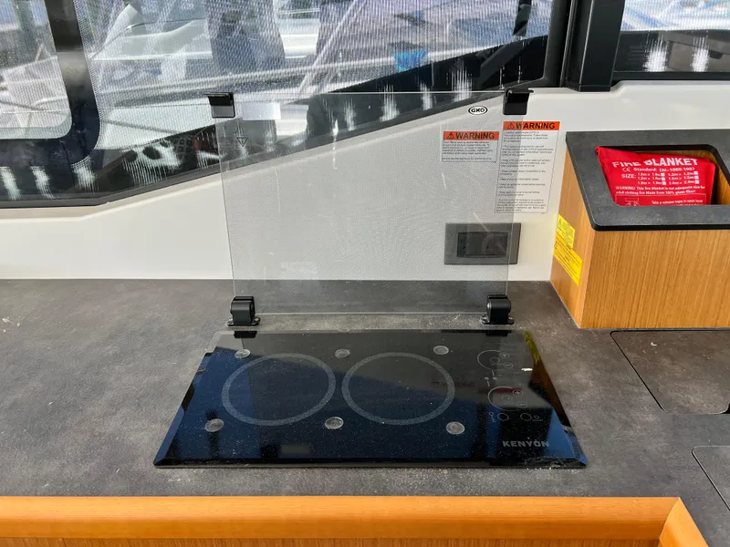 Slide: The Image of Beneteau Swift Trawler 35 2021 kitchen with glass cooktop and safety cover. - 17