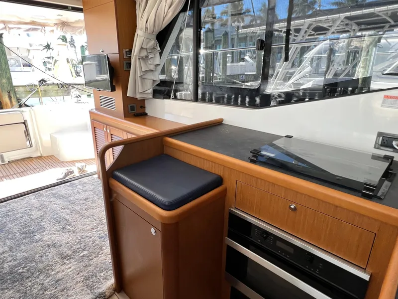Slide: The Image of Interior of 2021 Beneteau Swift Trawler 35 with modern kitchen and seating area. - 21