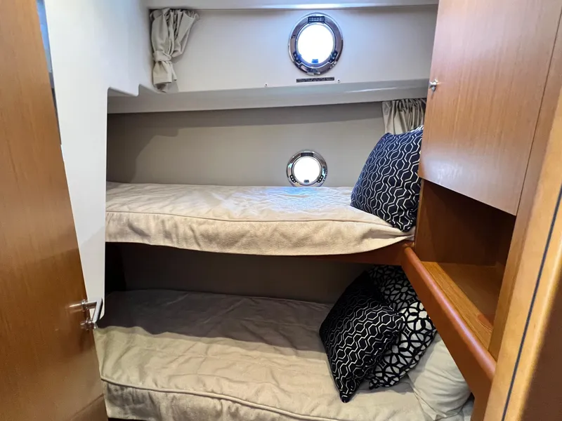 Slide: The Image of 2021 Beneteau Swift Trawler 35 cabin with bunk beds and porthole windows. - 22