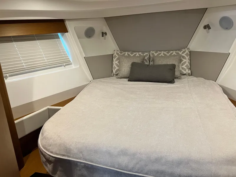 Slide: The Image of 2021 Beneteau Swift Trawler 35 bedroom with modern decor and comfortable bedding. - 26