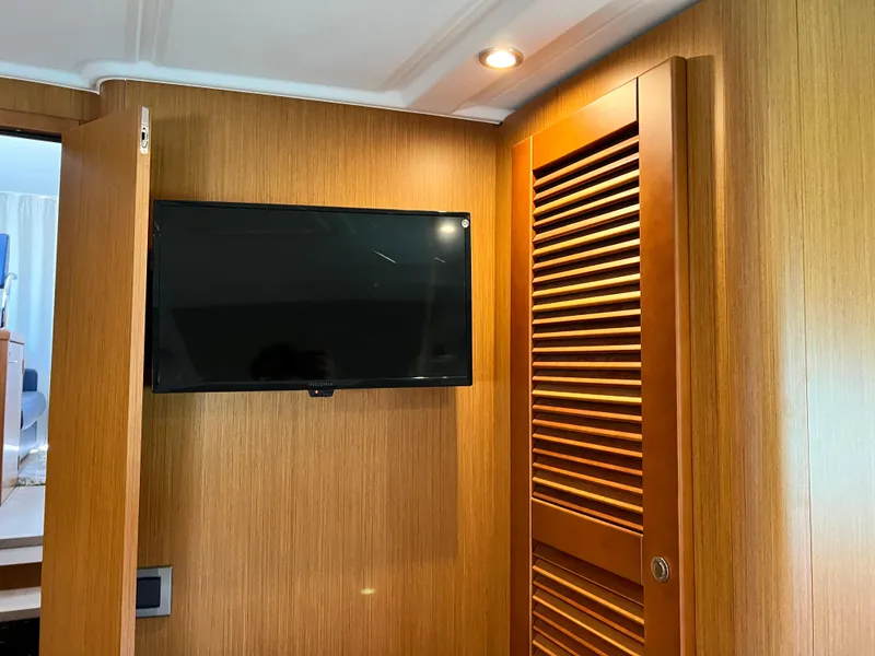 Slide: The Image of Flat-screen TV mounted on wooden wall inside 2021 Beneteau Swift Trawler 35. - 31