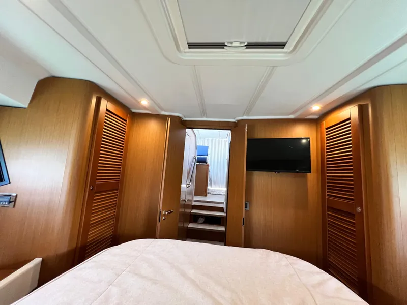 Slide: The Image of Interior cabin of 2021 Beneteau Swift Trawler 35 with wood paneling and TV. - 32