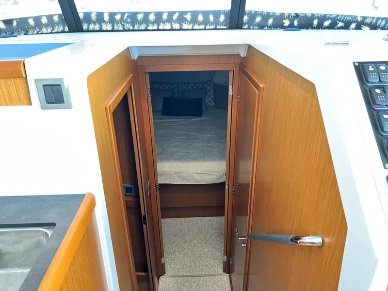 Slide: The Image of Interior cabin view of 2021 Beneteau Swift Trawler 35, featuring a cozy bed. - 36