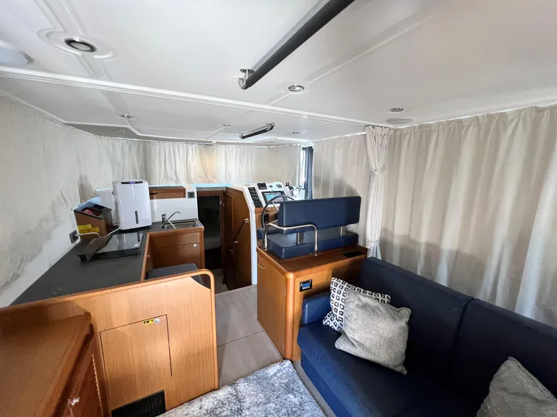 Slide: The Image of Interior of 2021 Beneteau Swift Trawler 35 with modern furnishings and helm station. - 37
