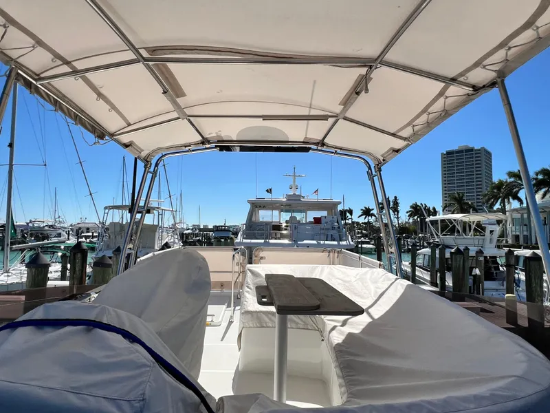 Slide: The Image of 2021 Beneteau Swift Trawler 35 at marina, covered seating area, sunny day. - 42