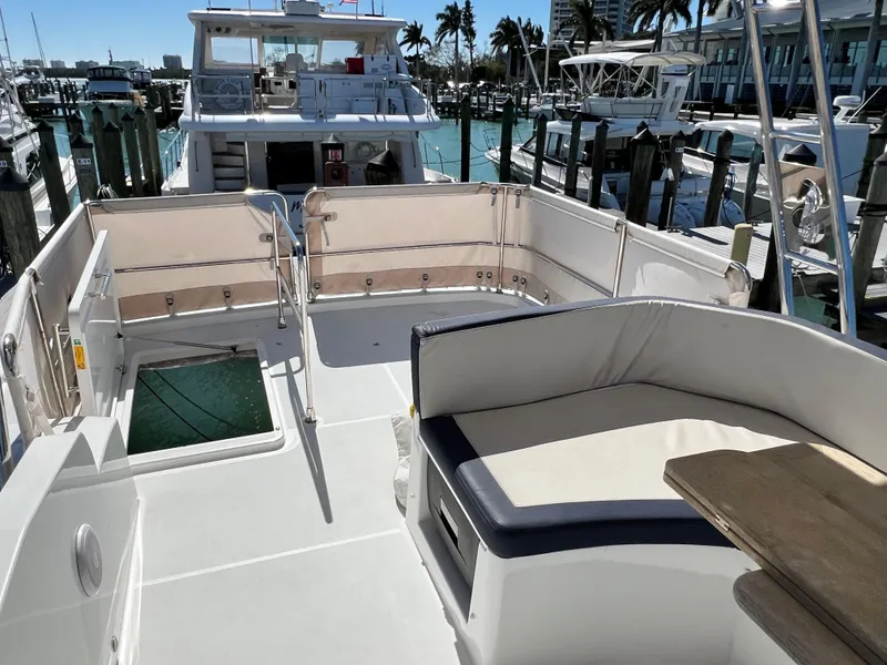 Slide: The Image of 2021 Beneteau Swift Trawler 35, spacious deck with seating, docked at marina. - 50