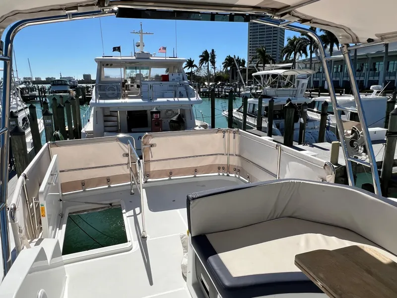 Slide: The Image of 2021 Beneteau Swift Trawler 35 at marina, spacious deck, sunny day. - 51