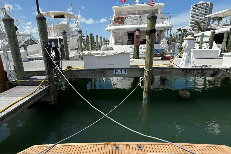 Slide: The Image of Beneteau Swift Trawler 35, 2021 model, docked at marina with clear blue sky. - 55