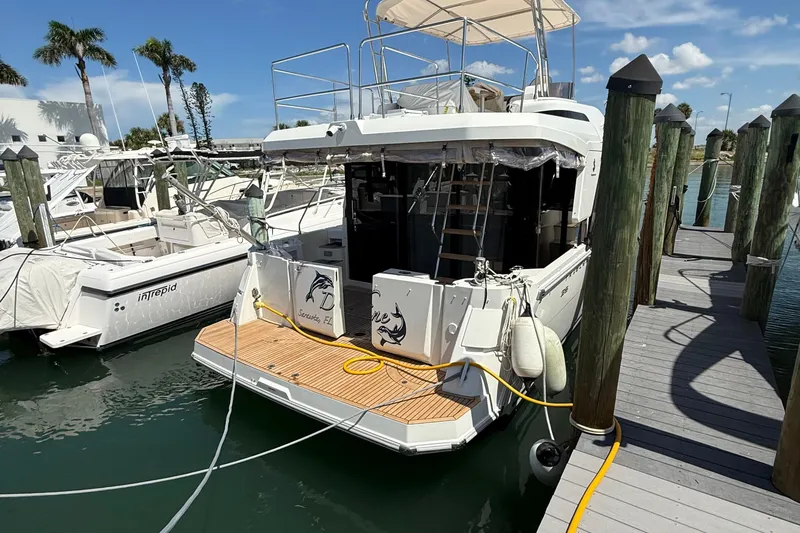 Slide: The Image of 2021 Beneteau Swift Trawler 35 docked at marina, featuring spacious deck and modern design. - 56