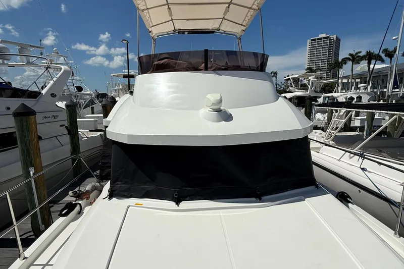 Slide: The Image of 2021 Beneteau Swift Trawler 35 docked at marina under clear blue sky. - 7