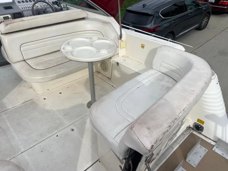 Slide: The Image of 1991 Cruisers Yachts Rouge 33 interior with white seating and round table. - 11