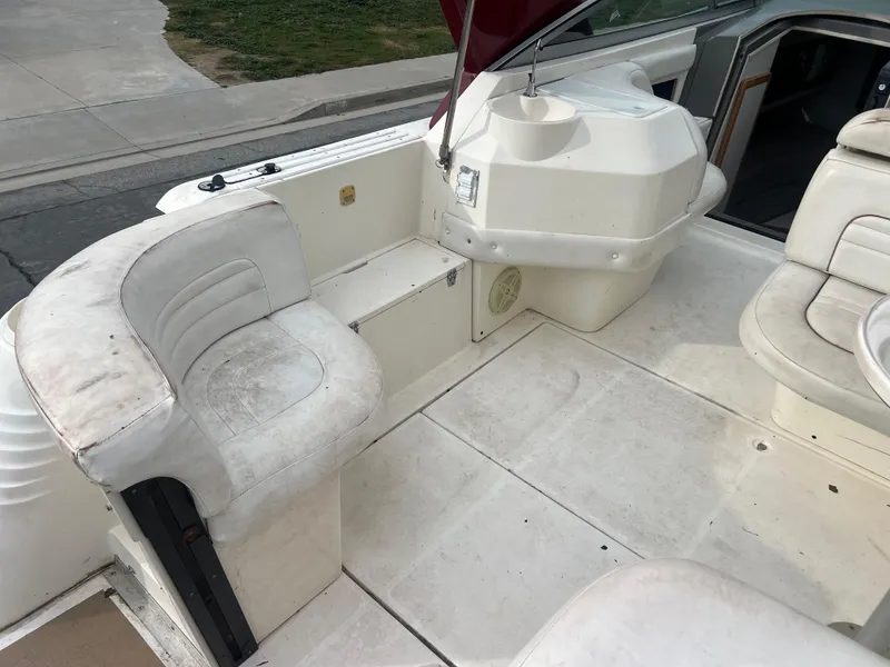 Slide: The Image of 1991 Cruisers Yachts Rouge 33 boat interior with white seating and helm station. - 12