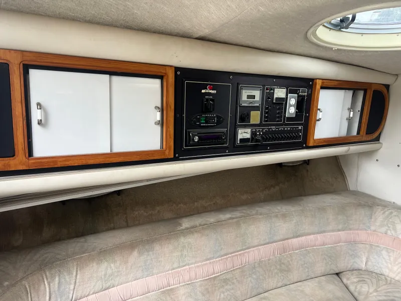 Slide: The Image of 1991 Cruisers Yachts Rouge 33 cabin interior with control panel and storage cabinets. - 24
