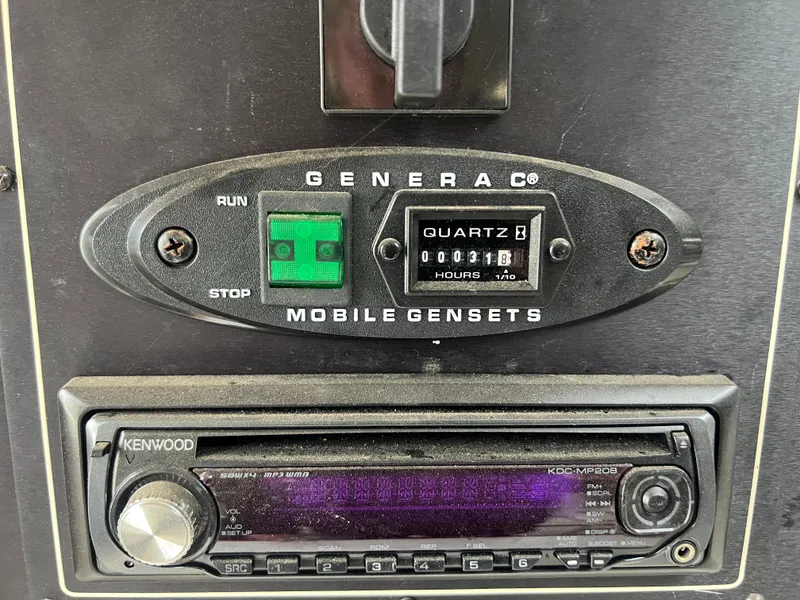 Slide: The Image of Generac mobile genset control panel and Kenwood radio on 1991 Cruisers Yachts Rouge 33. - 25