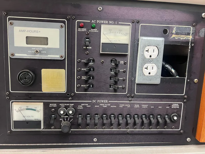 Slide: The Image of 1991 Cruisers Yachts Rouge 33 electrical control panel with AC and DC power switches. - 26