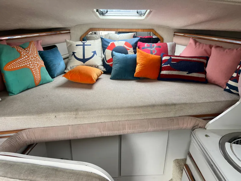 Slide: The Image of 1991 Cruisers Yachts Rouge 33 interior with colorful nautical-themed pillows. - 28