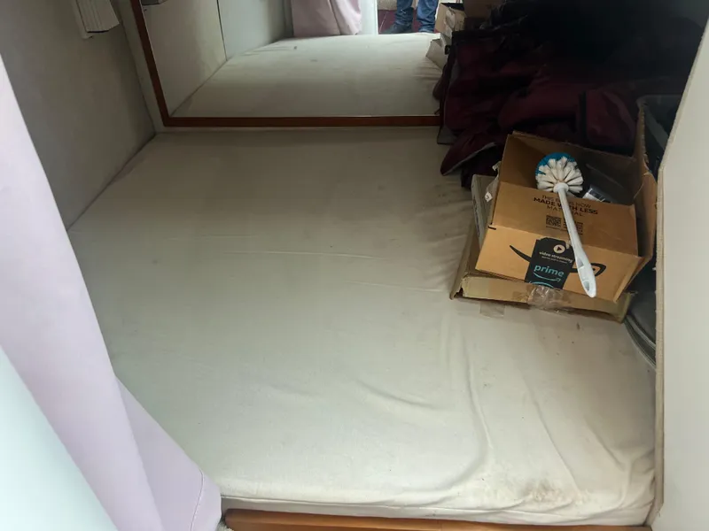 Slide: The Image of 1991 Cruisers Yachts Rouge 33 cabin interior with bed and storage boxes. - 31