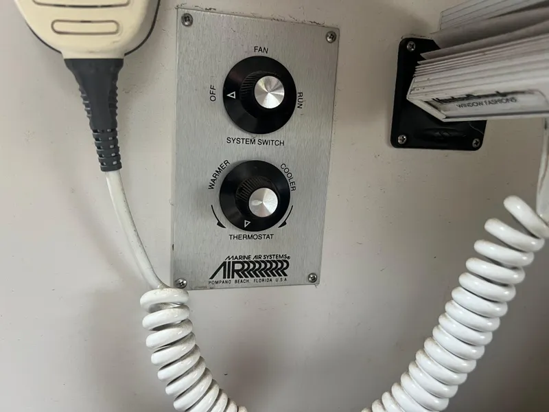 Slide: The Image of Cruisers Yachts Rouge 33 1991 control panel with system switch and thermostat. - 34