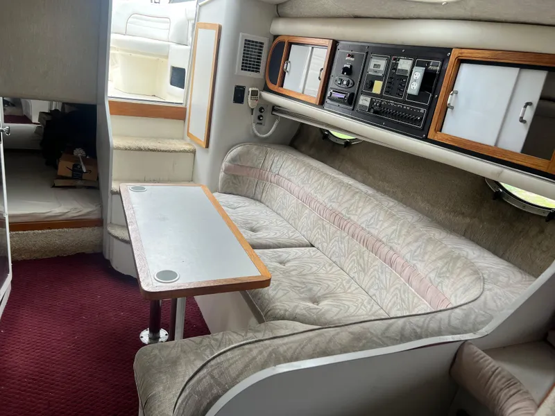 Slide: The Image of 1991 Cruisers Yachts Rouge 33 interior with beige seating and control panel. - 36