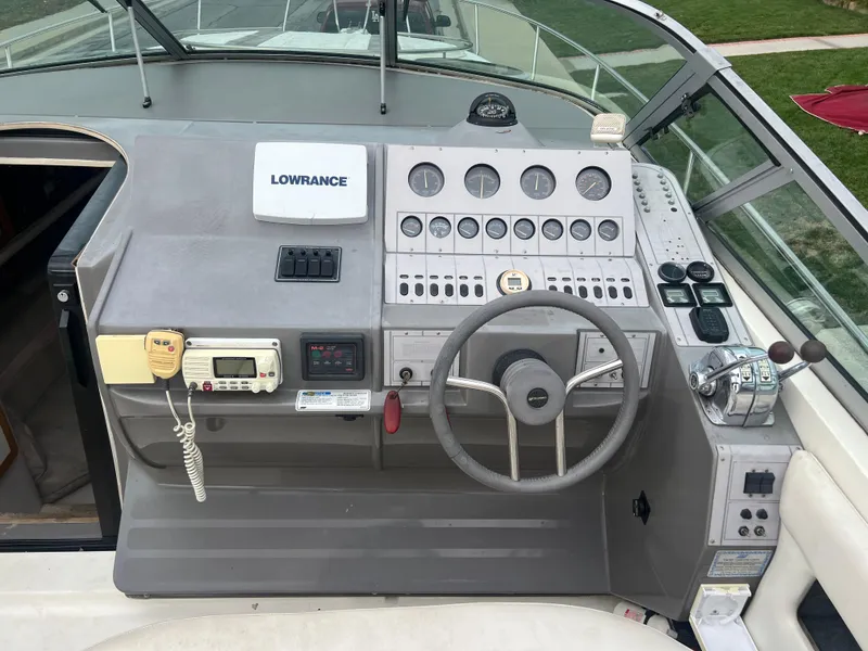 Slide: The Image of 1991 Cruisers Yachts Rouge 33 boat dashboard with steering wheel and navigation equipment. - 14