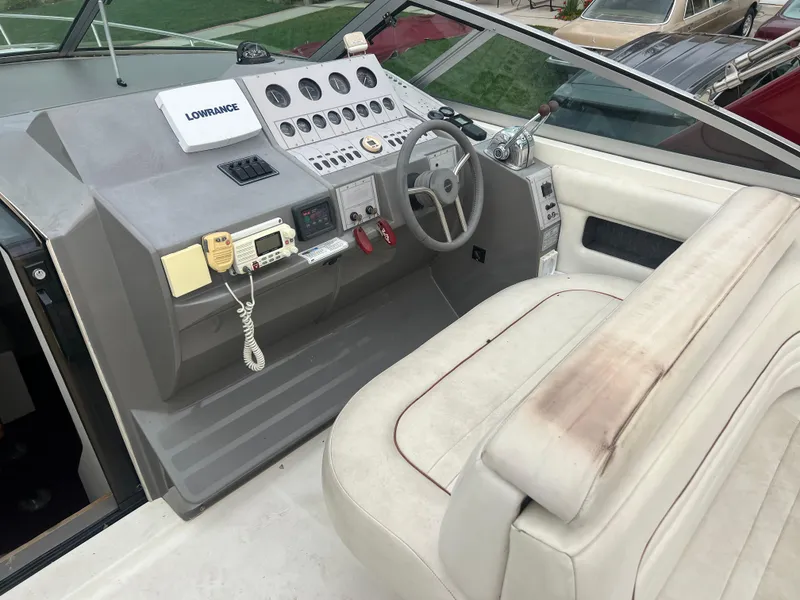 Slide: The Image of 1991 Cruisers Yachts Rouge 33 helm with navigation equipment and white leather seating. - 15