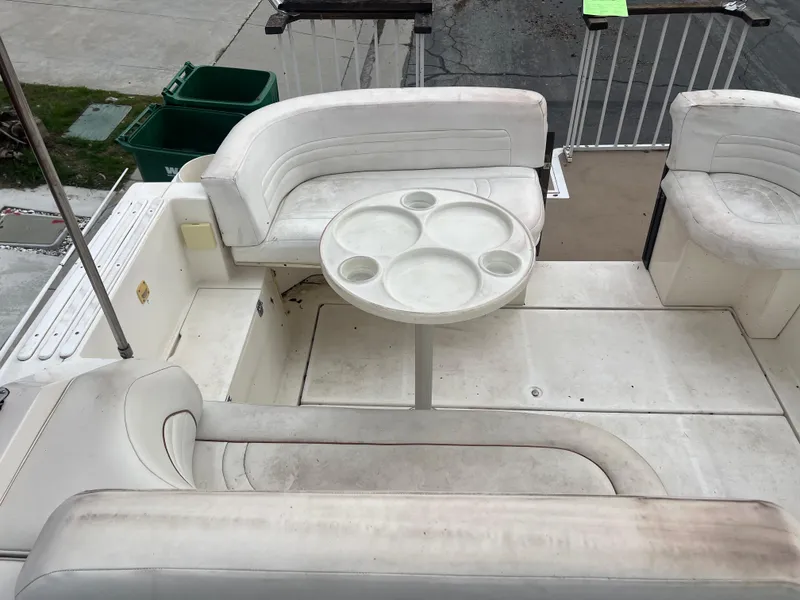 Slide: The Image of 1991 Cruisers Yachts Rouge 33 boat interior with white seating and round table. - 17