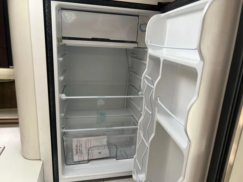 Slide: The Image of Open refrigerator inside a 1991 Cruisers Yachts Rouge 33 boat. - 35