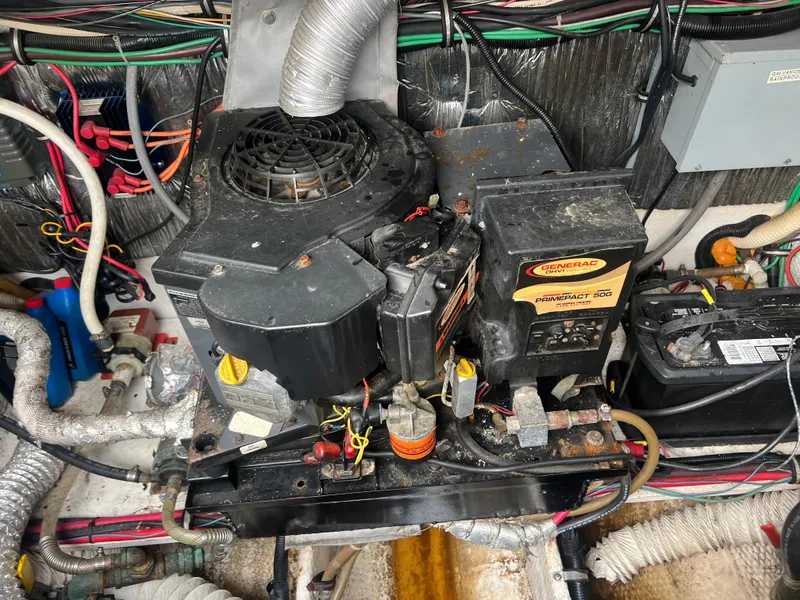 Slide: The Image of 1991 Cruisers Yachts Rouge 33 engine compartment with wiring and mechanical components. - 38