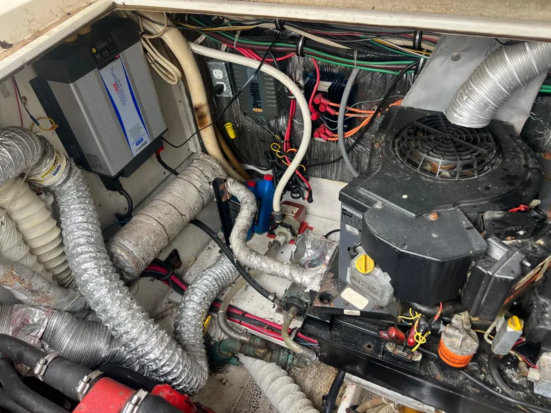 Slide: The Image of 1991 Cruisers Yachts Rouge 33 engine compartment with wiring and mechanical components. - 39