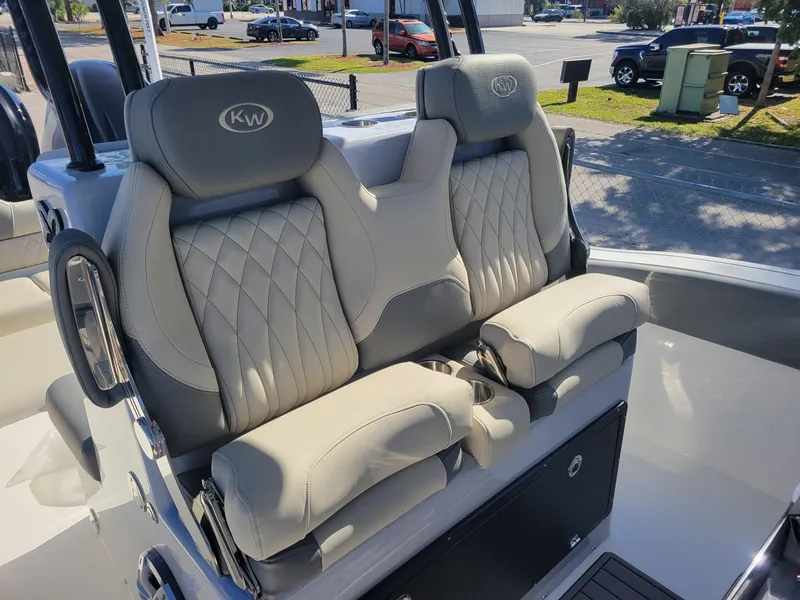 Slide: The Image of 2025 Key West 291 FS boat with luxurious, diamond-stitched seating in a coastal setting. - 11