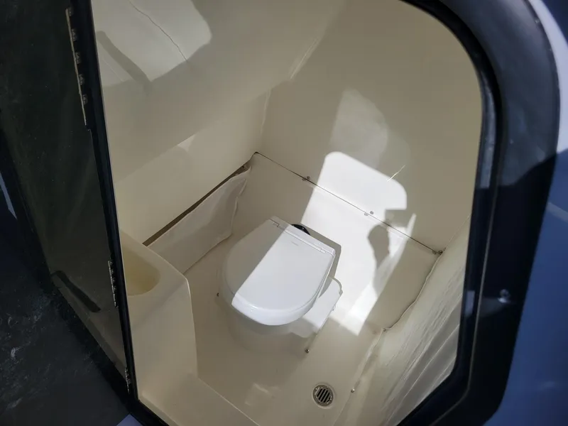Slide: The Image of 2025 Key West 291 FS boat interior bathroom with toilet. - 16