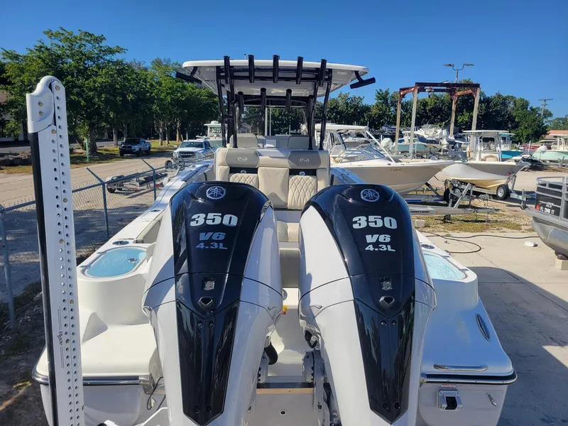 Slide: The Image of 2025 Key West 291 FS boat with dual 350 V6 engines in a marina setting. - 2