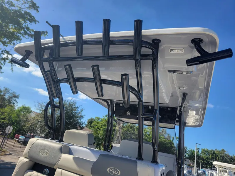 Slide: The Image of 2025 Key West 291 FS boat with rod holders and T-top against blue sky. - 8