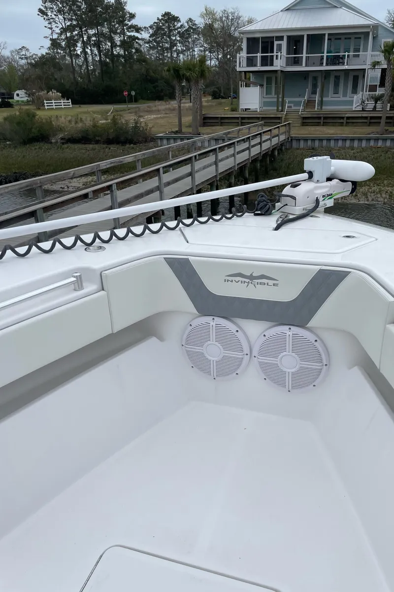 Slide: The Image of 2022 Invincible 36 Open Fisherman boat docked near a waterfront home. - 7