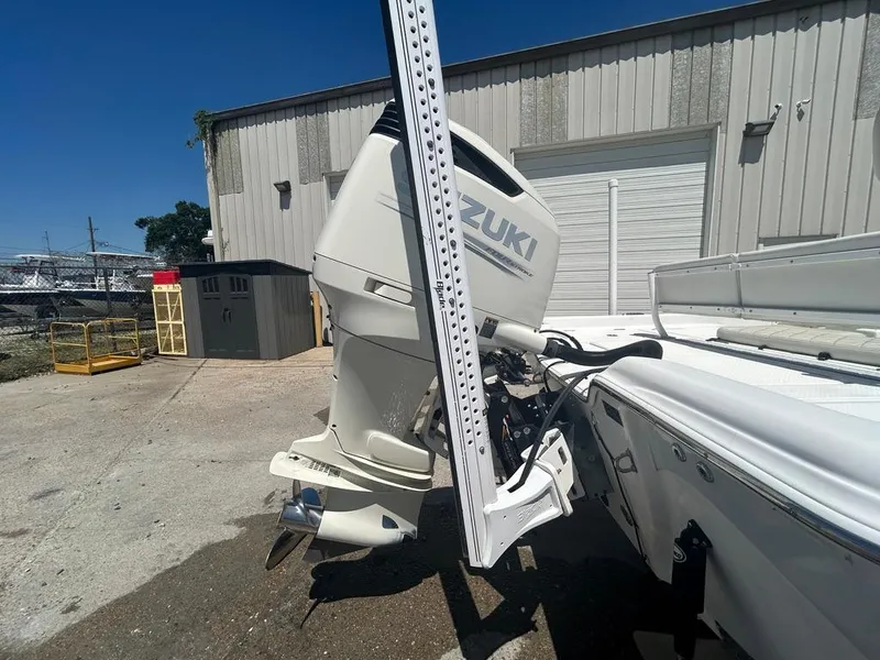 Slide: The Image of 2019 Blue Wave 2400 PureBay boat with Suzuki outboard motor in a yard. - 11