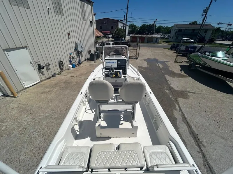 Slide: The Image of 2019 Blue Wave 2400 PureBay boat docked, interior view with seating and console. - 14