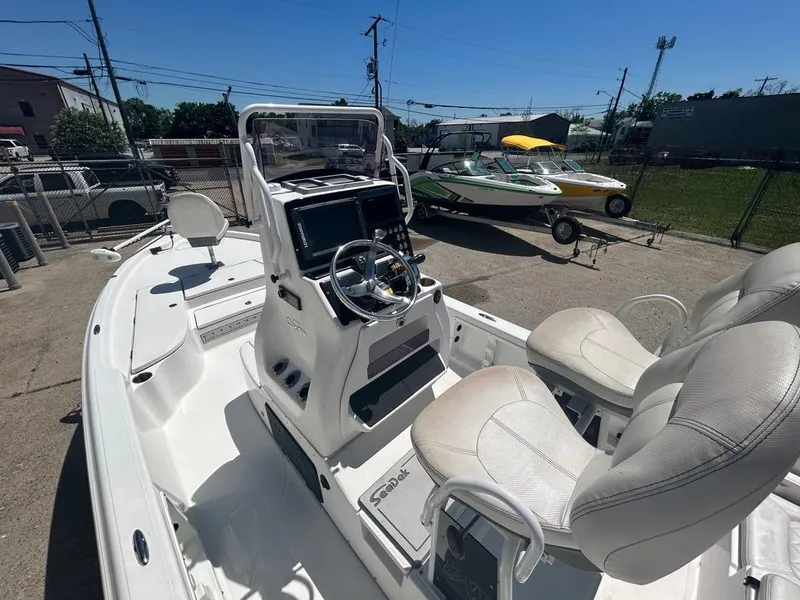 Slide: The Image of 2019 Blue Wave 2400 PureBay boat interior with dual seats and control console. - 18