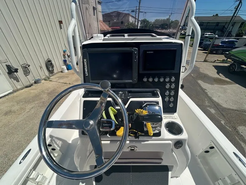 Slide: The Image of 2019 Blue Wave 2400 PureBay boat console with steering wheel and navigation equipment. - 19