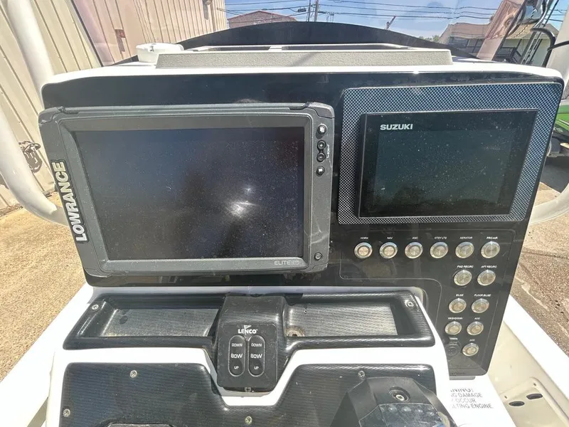 Slide: The Image of 2019 Blue Wave 2400 PureBay boat dashboard with Lowrance and Suzuki displays. - 20