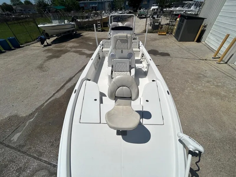 Slide: The Image of 2019 Blue Wave 2400 PureBay boat with seating and console, docked at a marina. - 23