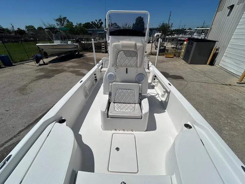 Slide: The Image of 2019 Blue Wave 2400 PureBay boat interior, featuring white seating and storage compartments. - 24