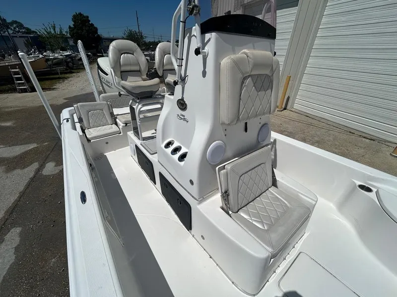 Slide: The Image of 2019 Blue Wave 2400 PureBay boat interior with white cushioned seats and console. - 25