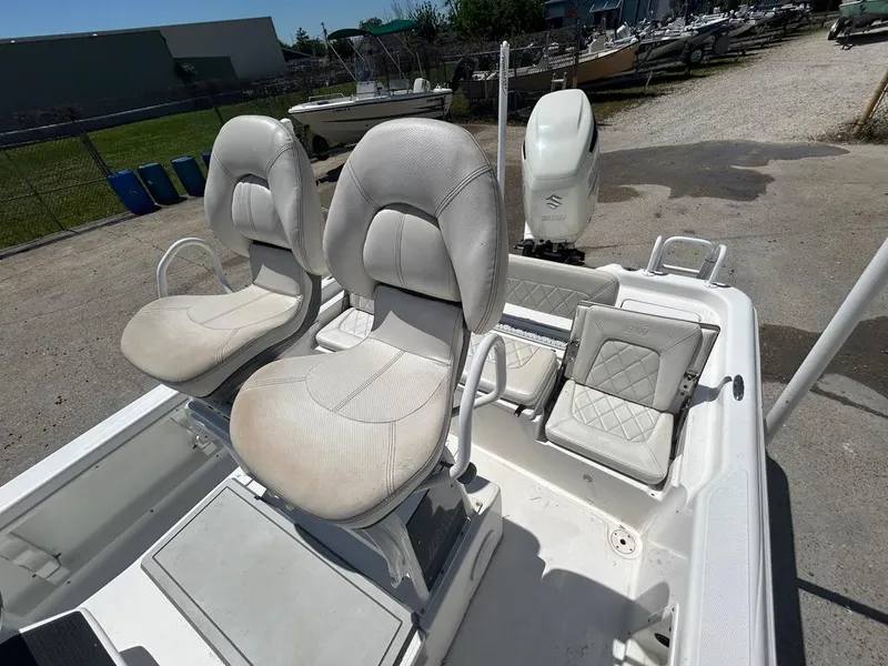 Slide: The Image of 2019 Blue Wave 2400 PureBay boat with dual captain's chairs and rear seating. - 28