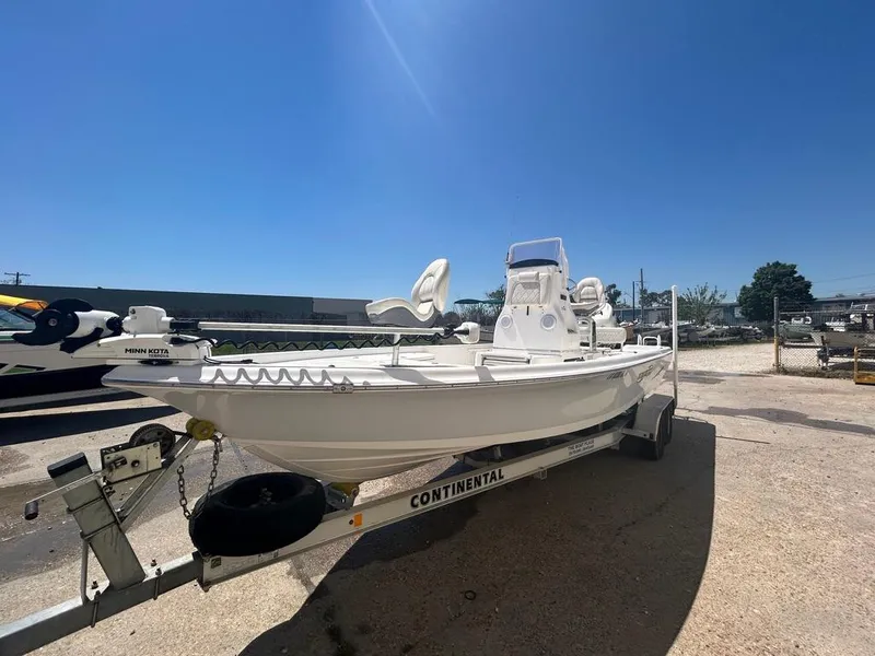 Slide: The Image of 2019 Blue Wave 2400 PureBay boat on Continental trailer under clear blue sky. - 4