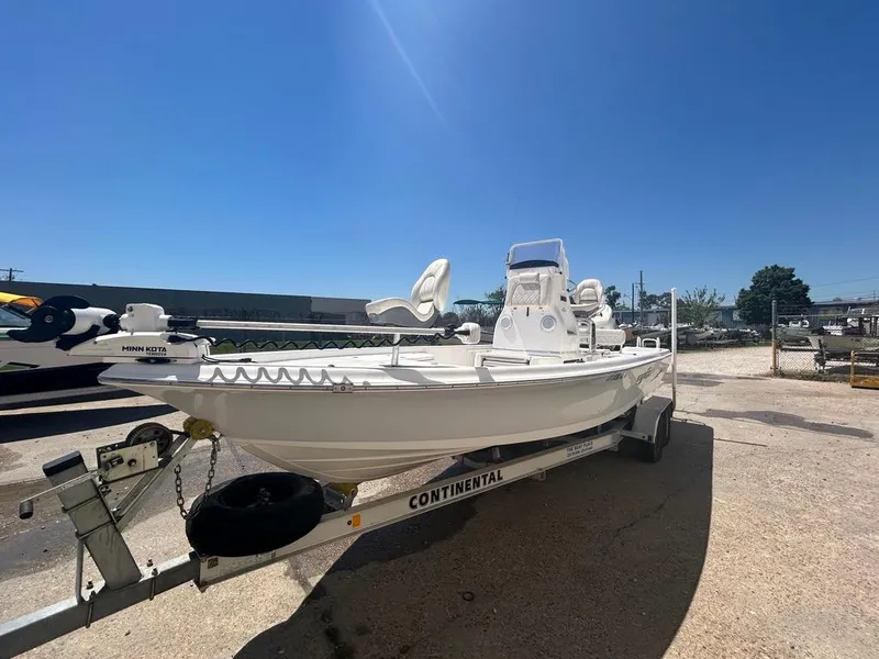 Slide: The Image of 2019 Blue Wave 2400 PureBay boat on Continental trailer under clear blue sky. - 5