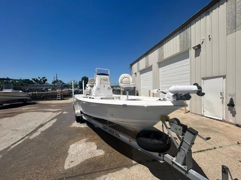 Slide: The Image of 2019 Blue Wave 2400 PureBay boat on a trailer outside a storage facility. - 6
