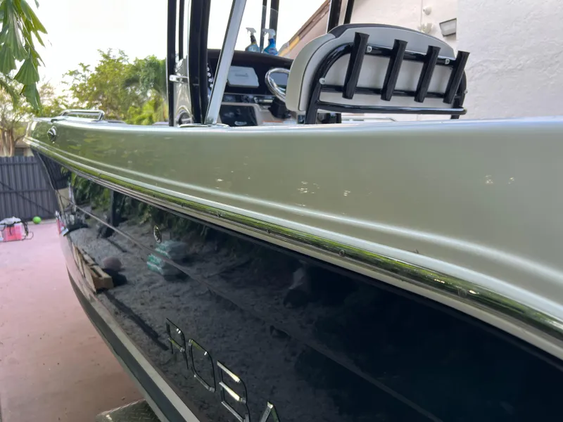Slide: The Image of 2018 Robalo R242 Center Console boat side view with rod holders. - 15