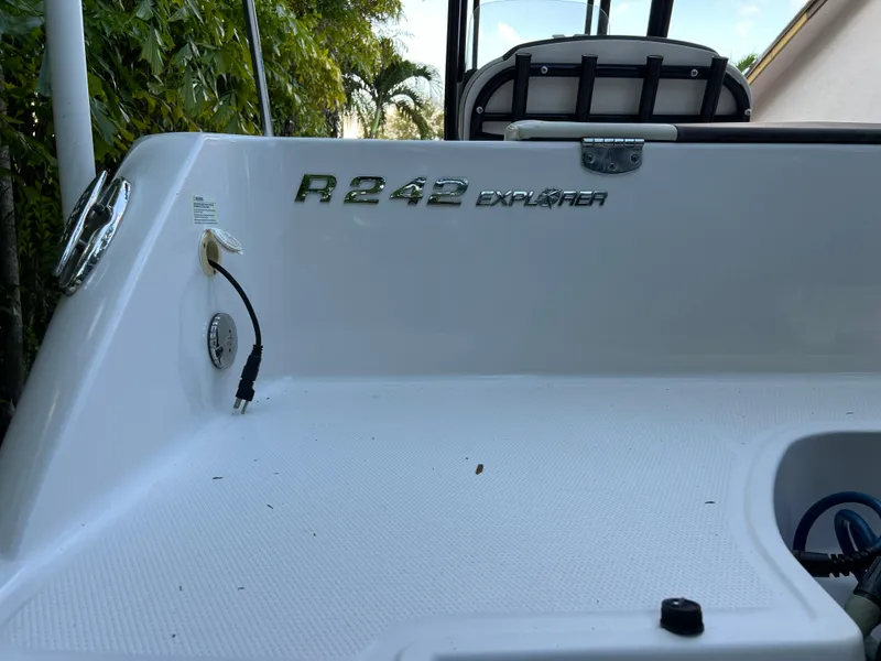 Slide: The Image of 2018 Robalo R242 Center Console boat deck with model name and logo. - 18