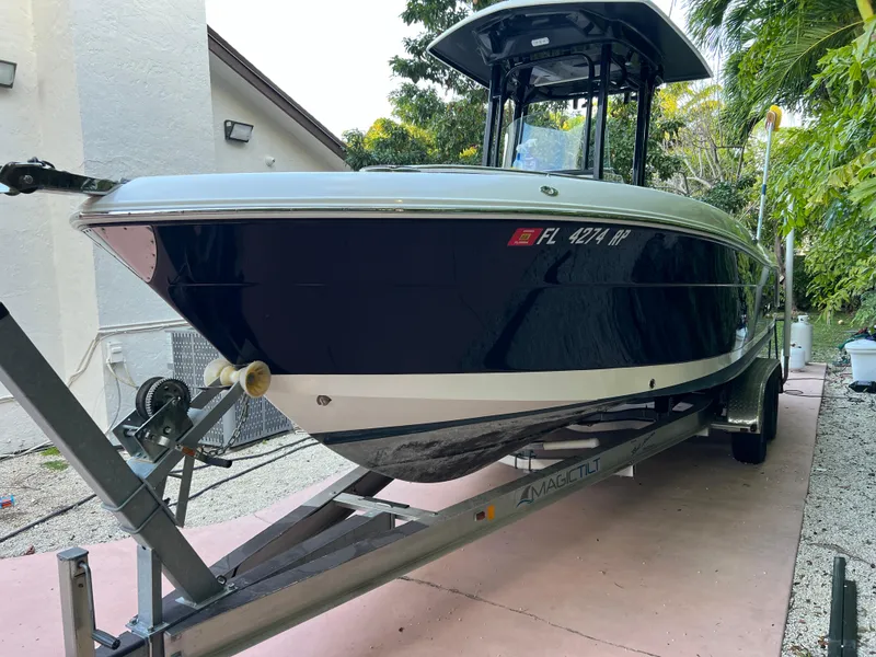 Slide: The Image of 2018 Robalo R242 Center Console boat on trailer in driveway. - 19