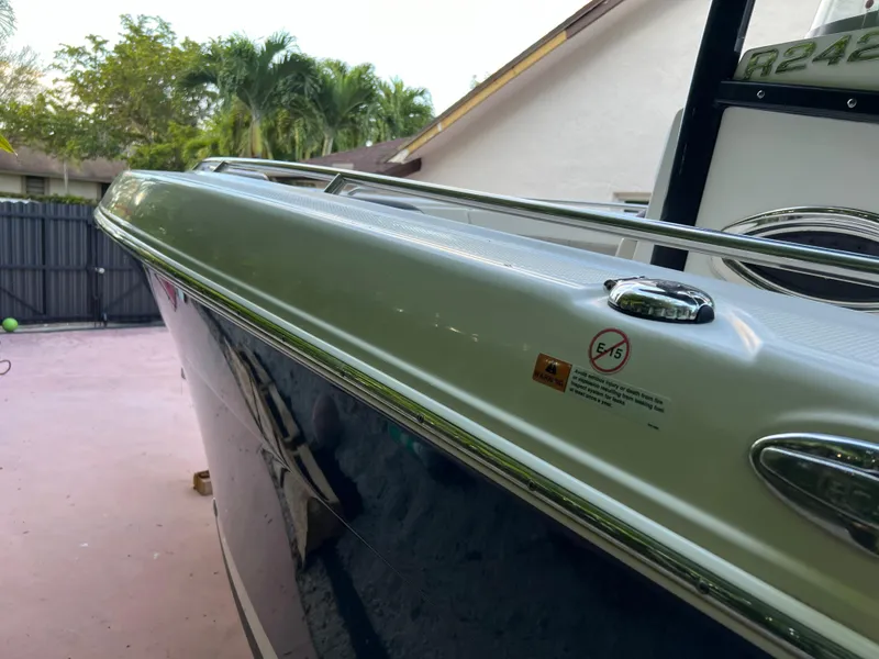 Slide: The Image of 2018 Robalo R242 Center Console boat side view in a residential driveway. - 20